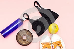 Sports equipment flat lay, and sneakers, old metal dumbbells and apples, water bottle and heart pillow. Concept healthy lifestyle,