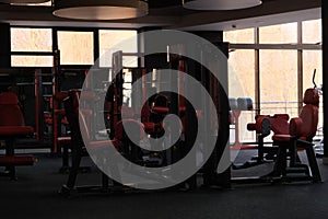 Sports equipment in the gym. Stylish sports space. Expanders and trainers with block weights.