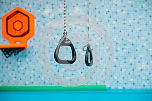 Sports equipment in the pool. Gymnastic rings hang above the water. Healthy lifestyle