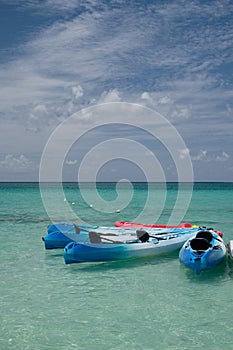 Sports equipment sits on the clear waters of the Cayman Islands