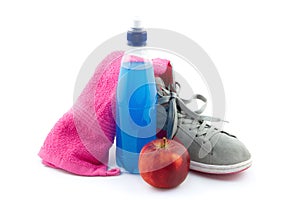 Sports equipment such as sneakers, energy drank, towel and apple