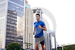 Sports, exercise and man running in the city for health, wellness or training for a marathon. Fitness, runner and male