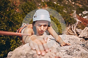 Sports, exercise and mountain climbing with a woman climber scaling or abseiling a cliff. Fitness, workout and training