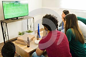 Sports fans looking worried while watching the soccer championship