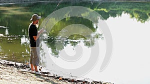 Sports fisherman fishing on lake, using fishing lures;