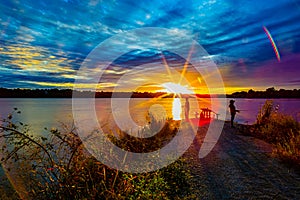 Sports Fishermen at Sunset early fall with beautiful skyline over Ed Zorinsky lake Omaha Nebraska