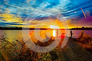 Sports Fishermen at Sunset early fall with beautiful skyline over Ed Zorinsky lake Omaha Nebraska