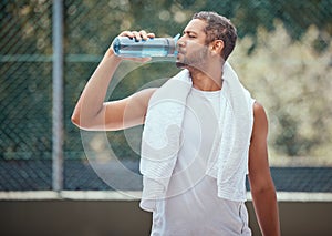 Sports, fitness and man on break drinking water after a workout, training session or exercise. Health, athlete and male