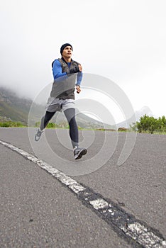 Sports, fitness and man running on road in training, cardio exercise or endurance workout for wellness. Energy, runner