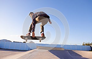 Sports, fitness and man with skateboard, jump or ramp action at a skate park for stunt training. Freedom, adrenaline and
