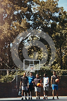 Sports, friends and basketball training at basketball court with group of men walking, talking and bonding before a