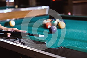 Sports game of billiards on a green cloth. Billiard balls with numbers on a pool table.