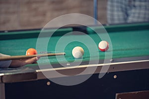 Sports game of billiards on a green cloth. Billiard balls with numbers on a pool table.