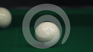 Sports game of billiards on a green cloth. Billiards white billiard balls close-up.
