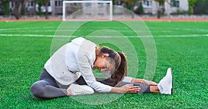 Sports girl doing morning gymnastics workout on a football field. Fitness, sport, health energy.