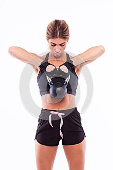 Sports girl with dumbbells in her hands on a light background