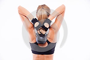 Sports girl with dumbbells in her hands on a light background