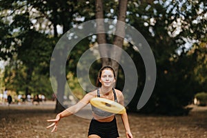 Sporty girls enjoying a sunny day in the park, playing frisbee and training outdoors, surrounded by nature.