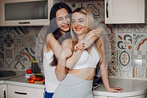 Sports girl in a kitchen with fruits