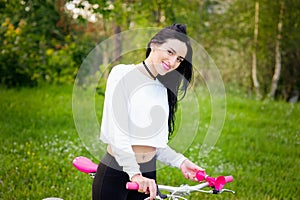 Sports girl rides a bicycle. emotions and lifestyle. Young beautiful woman riding a bike in the park. Active people. On the street