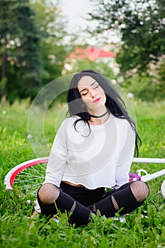 Sports girl rides a bicycle. emotions and lifestyle. Young beautiful woman riding a bike in the park. Active people. On the street