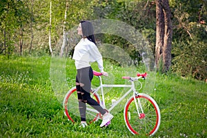 Sports girl rides a bicycle. emotions and lifestyle. Young beautiful woman riding a bike in the park. Active people. On the street