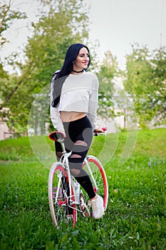 Sports girl rides a bicycle. emotions and lifestyle. Young beautiful woman riding a bike in the park. Active people. On the street