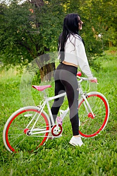 Sports girl rides a bicycle. emotions and lifestyle. Young beautiful woman riding a bike in the park. Active people. On the street