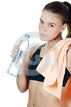 The sports girl with a towel and a water bottle