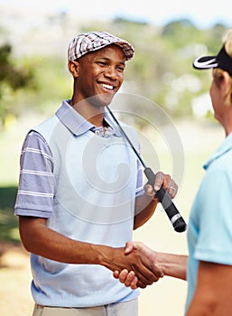 Sports, golf and athletes shaking hands on a field for competition, tournament or event. Smile, agreement and