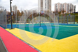 Sports ground for playing basketball with rubberized material tracks yellow lilac pink in the city outdoors. Sport is a healthy li