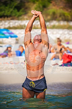 Sports guy on the beach in the summer season
