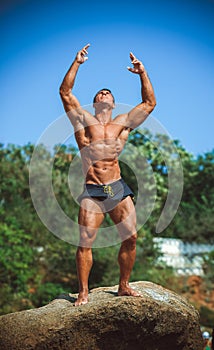 Sports guy on the beach in the summer season