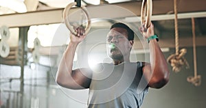 Sports, gymnastics and black man doing pull up exercise for arm muscle training or workout in gym. Fitness, bodybuilding