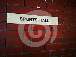 Sports hall sign on brick wall