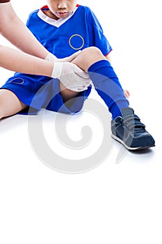 Sports injury. Doctor first aid at thigh of soccer player. Isola