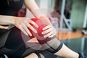 Sports injury at knee in fitness training gym. Training and medical concept. Health care and Sport exercise concept. Pain of body