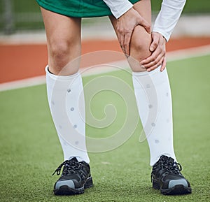 Sports, injury and legs of woman on field, grass or athlete walking with joint pain in soccer, accident or game. Medical