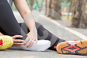 Sports injury. Woman with pain in ankle while jogging