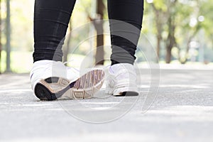 Sports injury. Woman with pain in ankle while jogging