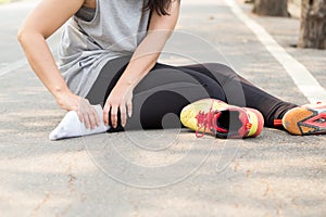 Sports injury. Woman with pain in ankle while jogging