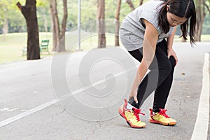 Sports injury. Woman with pain in ankle while jogging