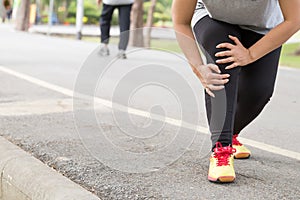 Sports injury. Woman with pain in knee while jogging