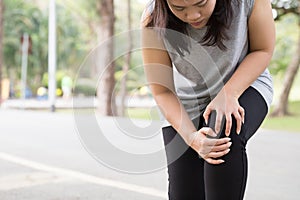 Sports injury. Woman with pain in knee while jogging