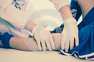 Sports injury. Youth soccer player in blue uniform. Knee joint pain