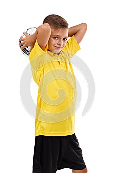 Sports kid isolated on a white background. Cute boy with a soccer ball. Young football player. Active childhood concept.