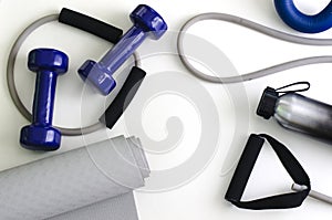 Sports kit: dumbbells, expander, yoga mat, water bottle. photo