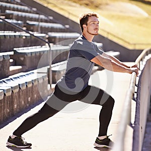 Sports, legs and man stretching at stadium for race, marathon or competition training for health. Fitness, wellness and