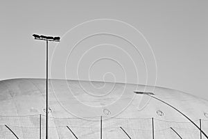 Sports lighting headlights near a pressure switch structure with a plastic cover of a sports building Pesaro, Italy