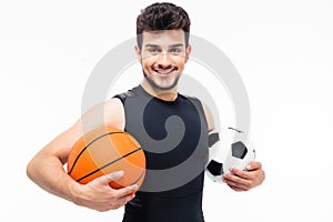 Sports man holding basketball and soccer ball